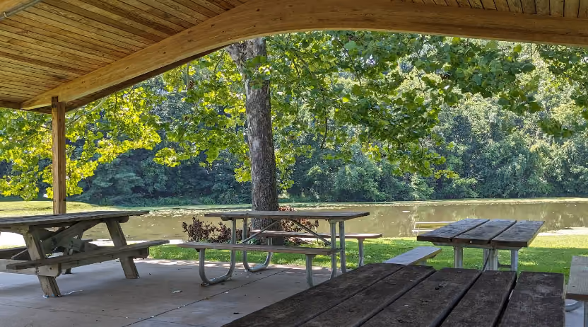 Buckeye Park picnic shelter with tables overlooking the pond