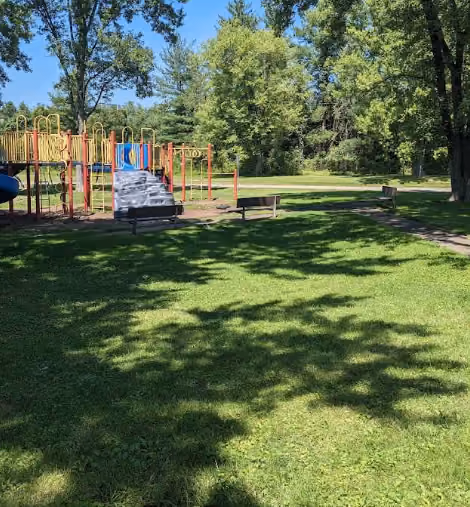 Buckeye Park playground with climbing structure, benches, and lawn