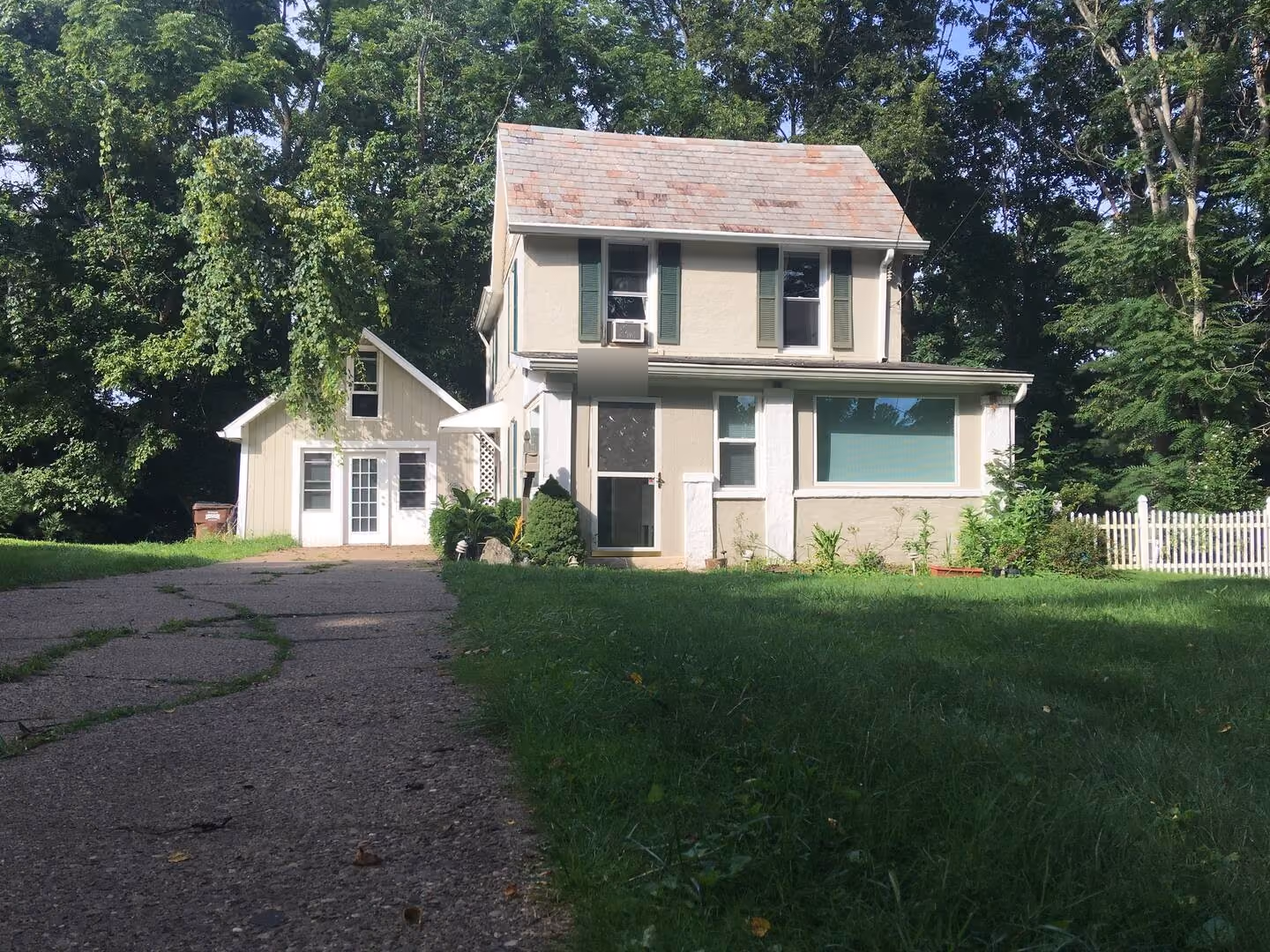 Frederick Cottage front exterior with driveway, lawn, and green shutters