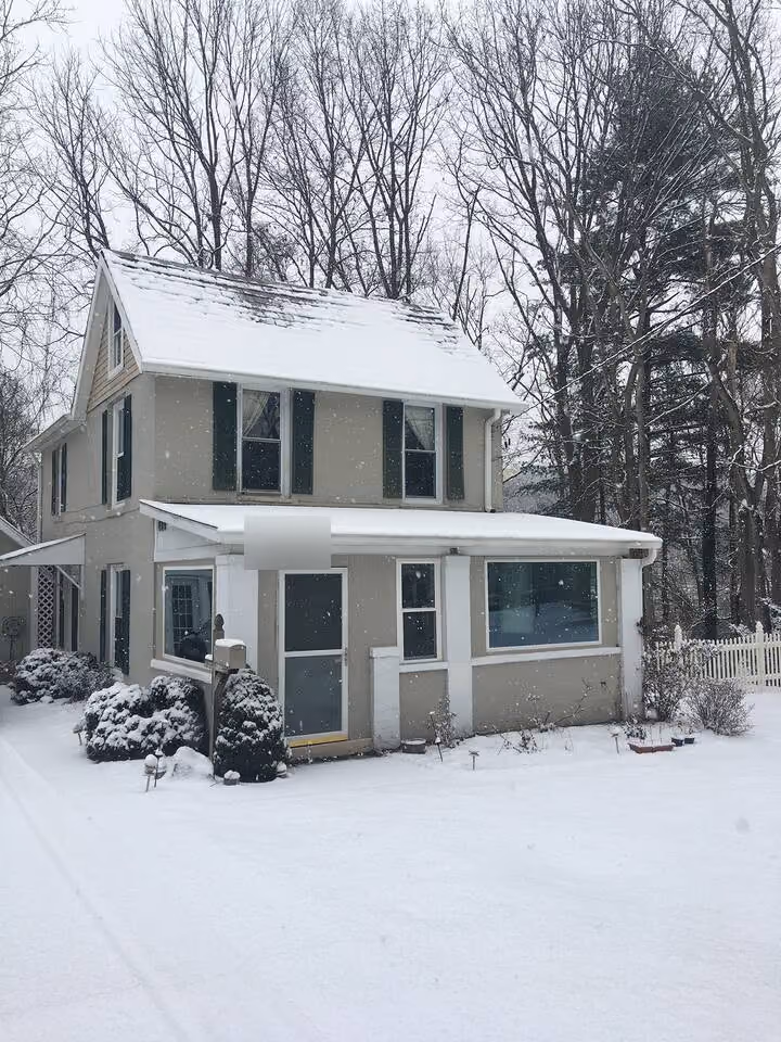 Frederick Cottage front exterior in snow with covered porch