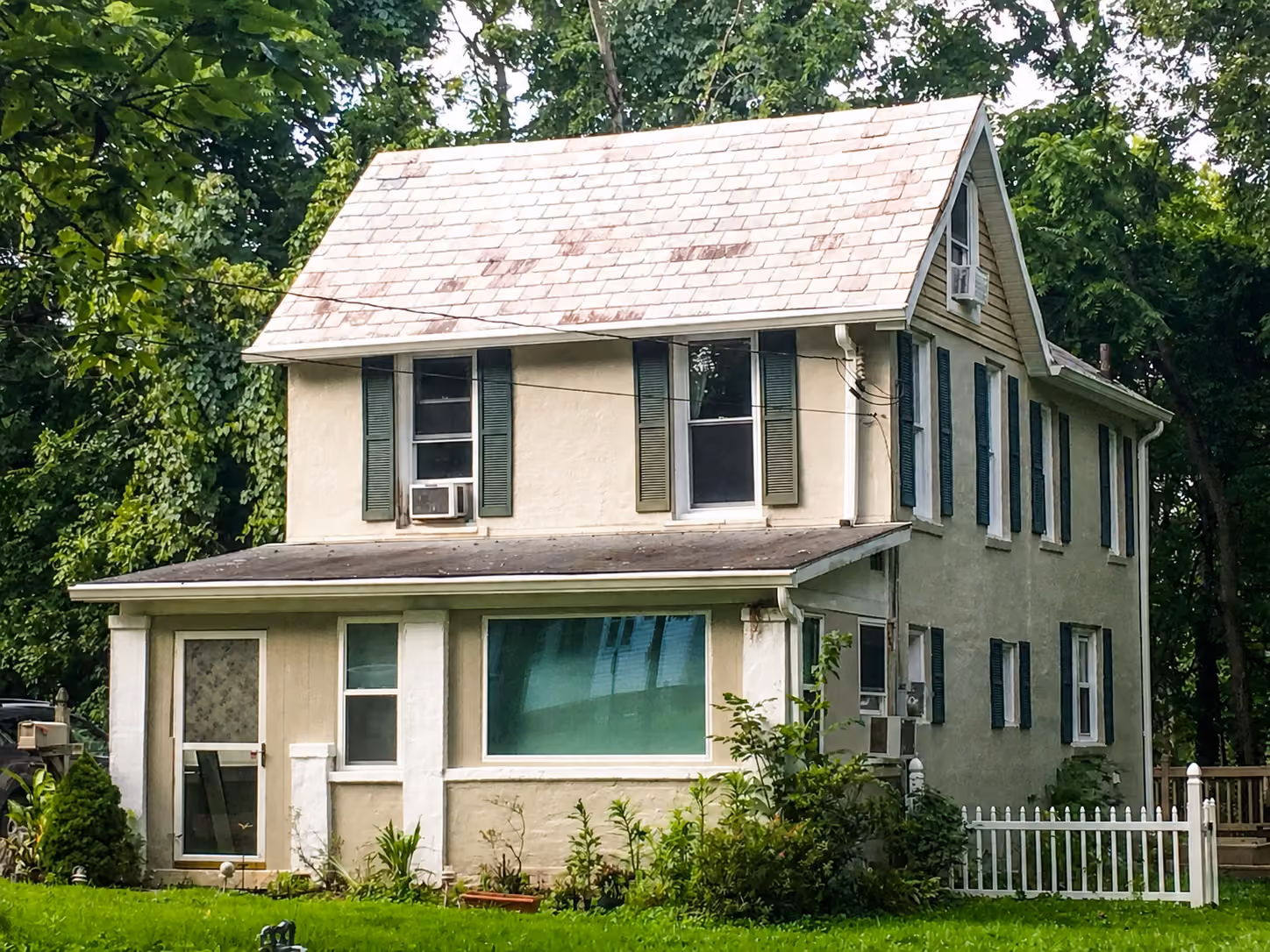 Frederick Cottage exterior with shutters, trees, lawn, and covered entry