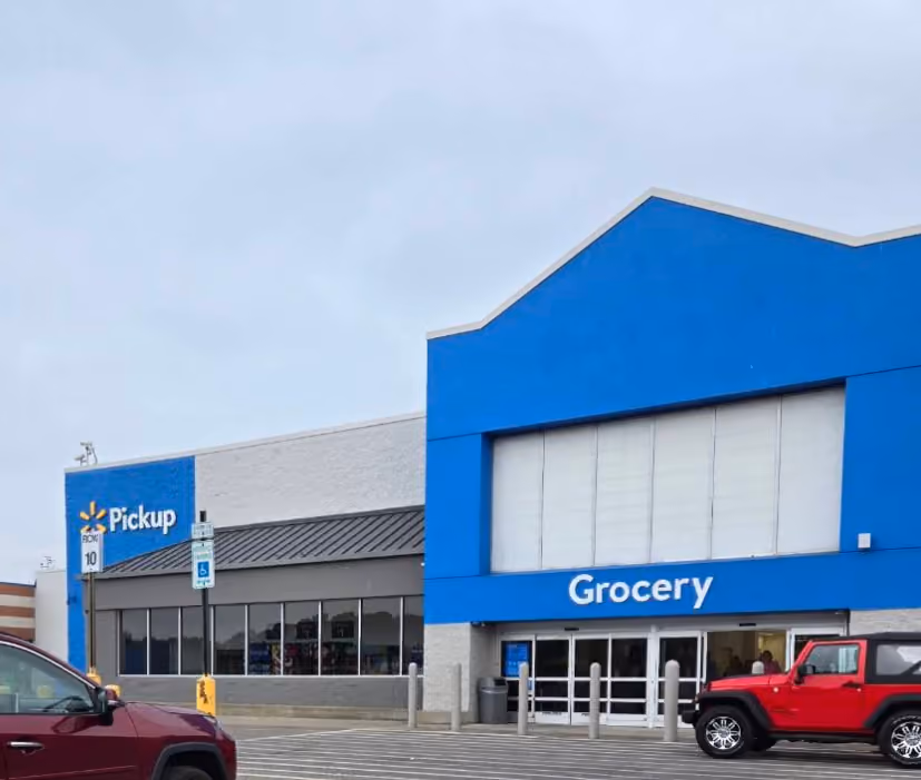 Walmart grocery pickup entrance with blue facade and parked cars