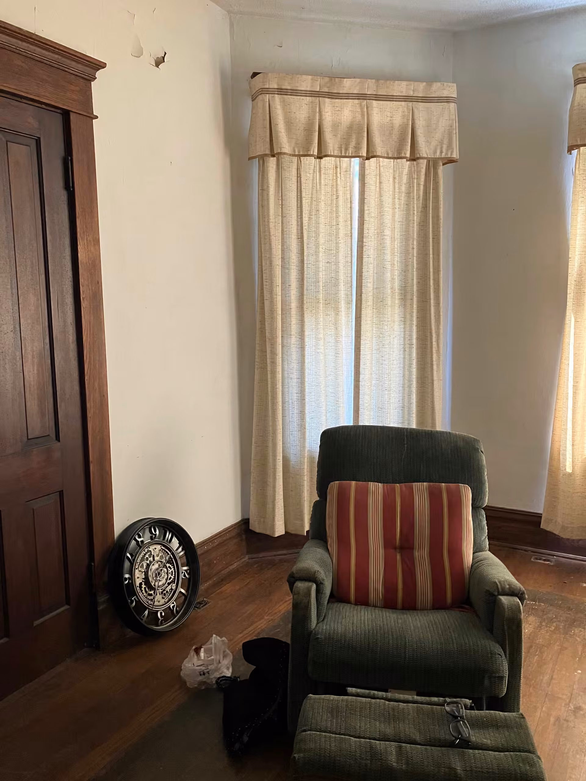 White Cottage living room reading corner with green chair