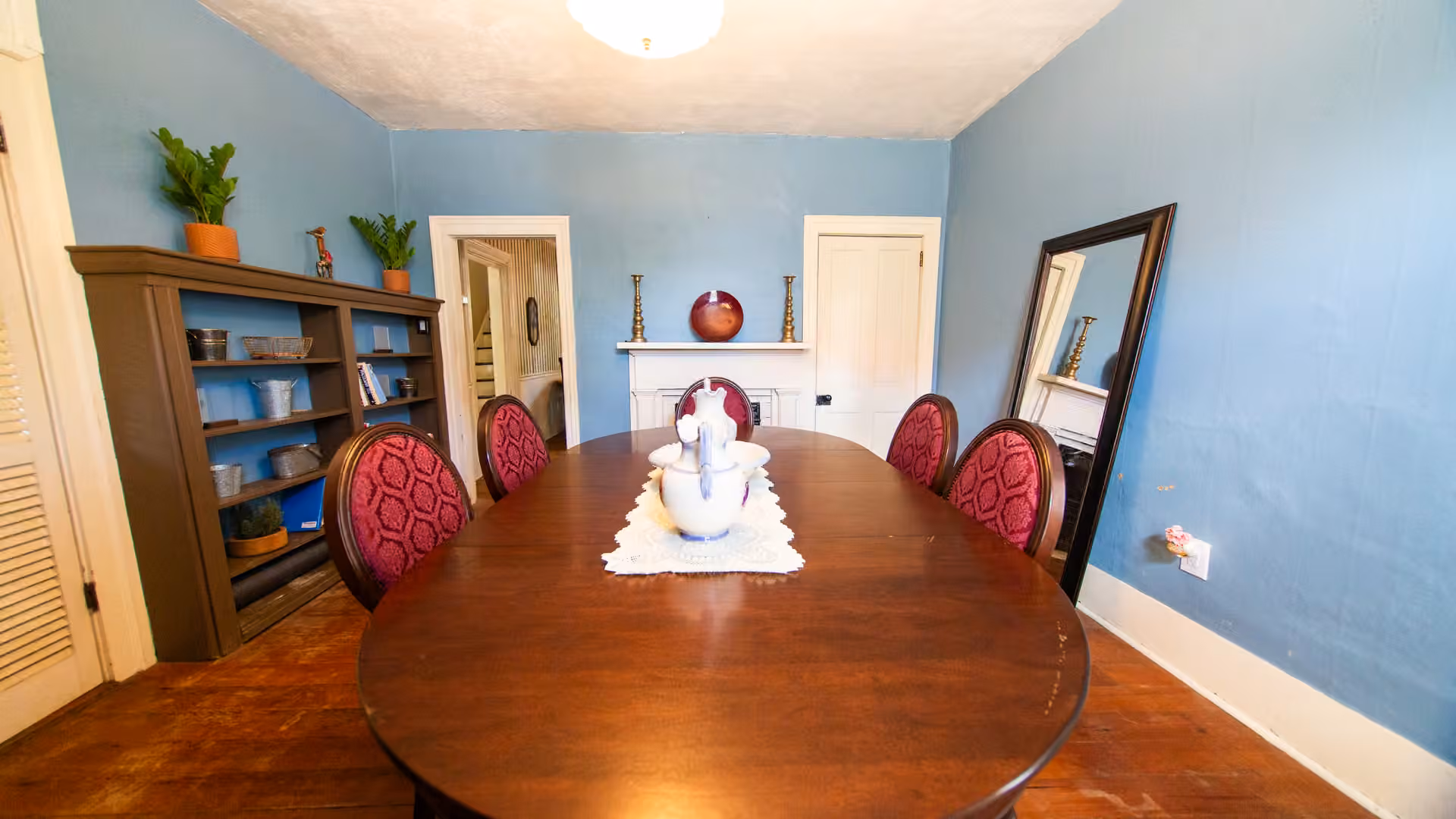 Henrietta Cottage dining room with blue walls, table, and chairs