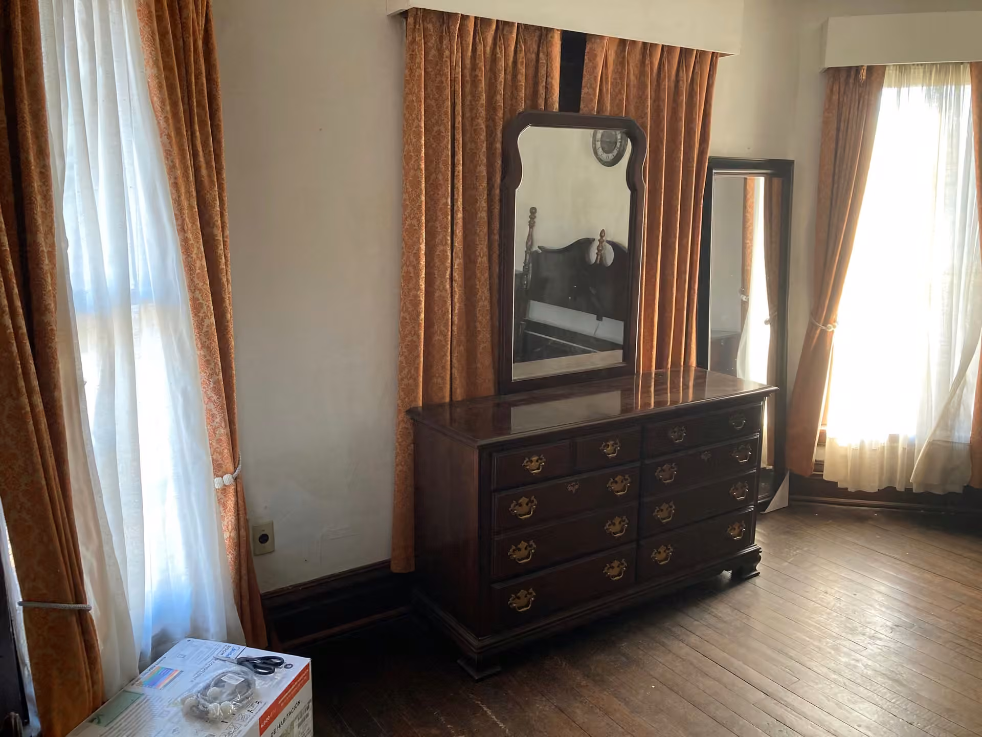 White Cottage bedroom storage with dresser and four-poster bed partly visible