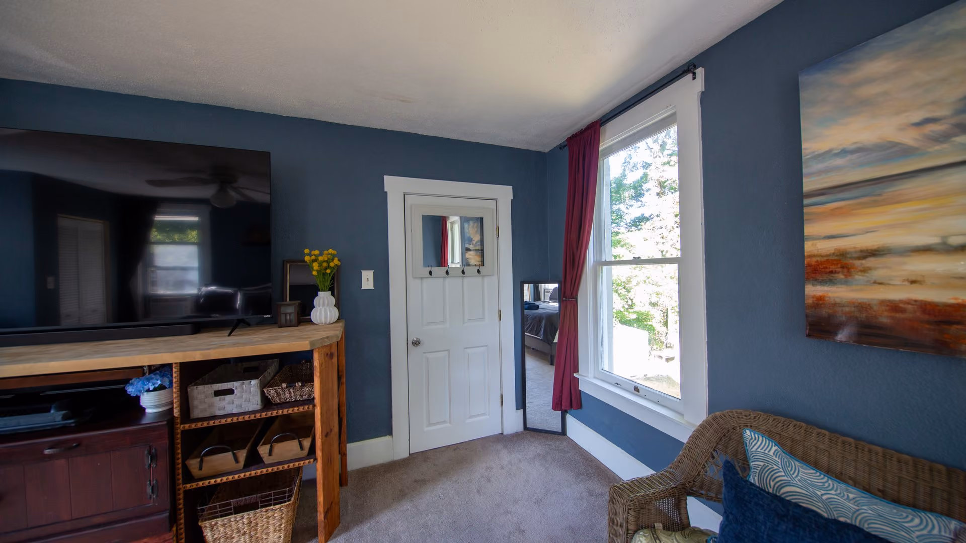 Frederick Cottage sitting room with blue walls, seating, and natural light