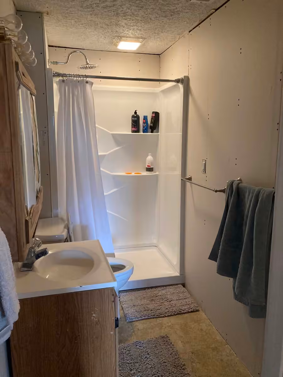 Buck Cottage bathroom with shower, sink, and toilet