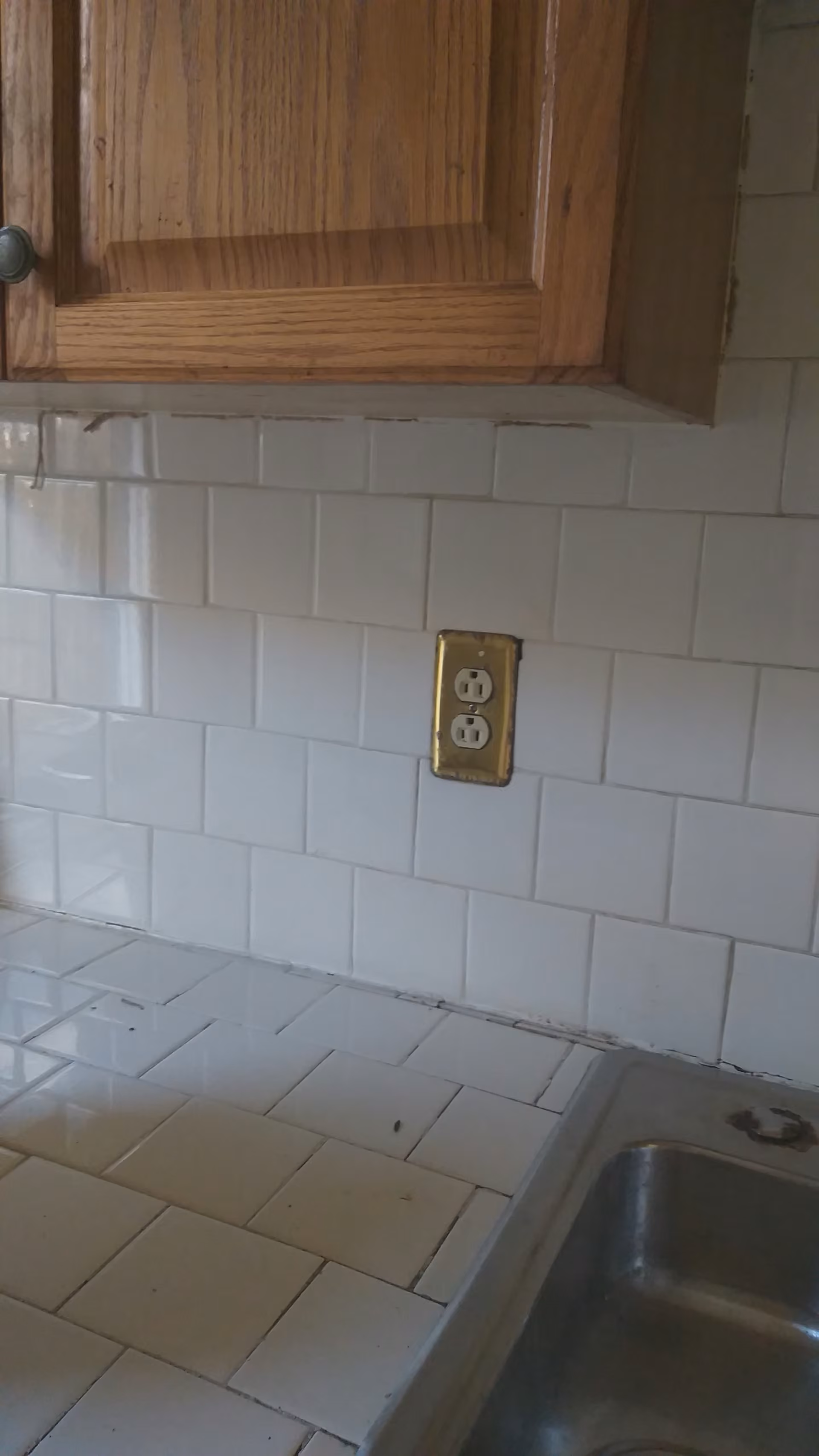 Yellow Cottage kitchen with tile backsplash, cabinets, and sink