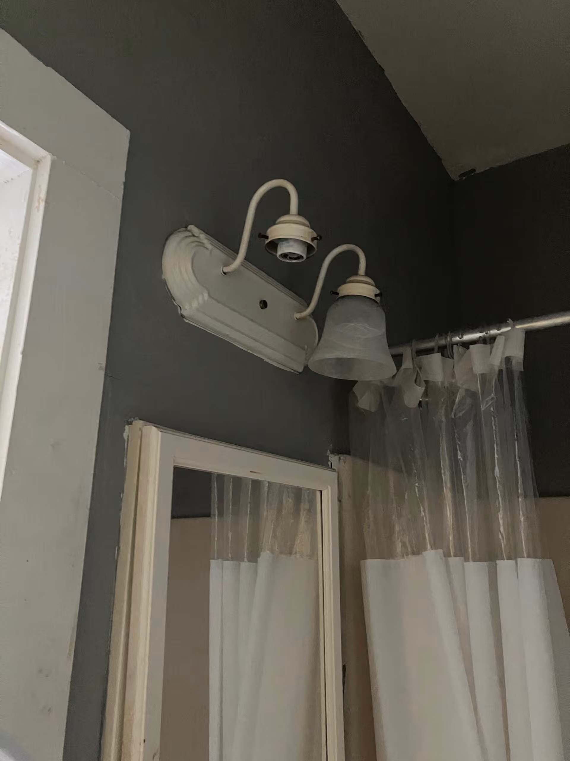 Yellow Cottage bathroom with light fixture and shower