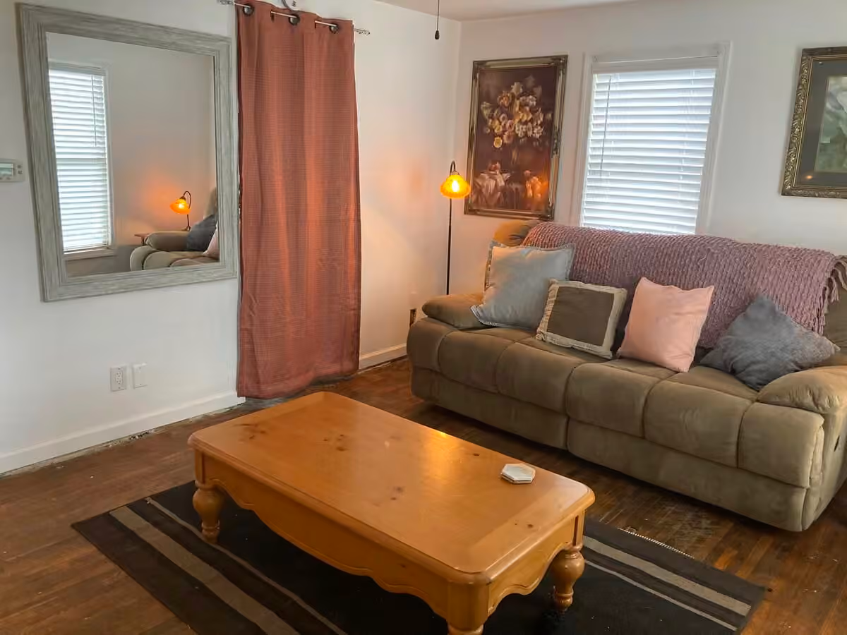 Buck Cottage living room with couch and windows